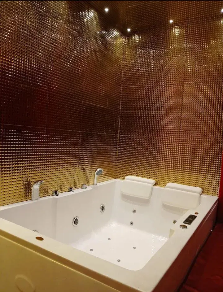 Private gold-tiled jacuzzi tub